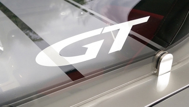 Fix mounted wind deflector clear with filled "GT" logo